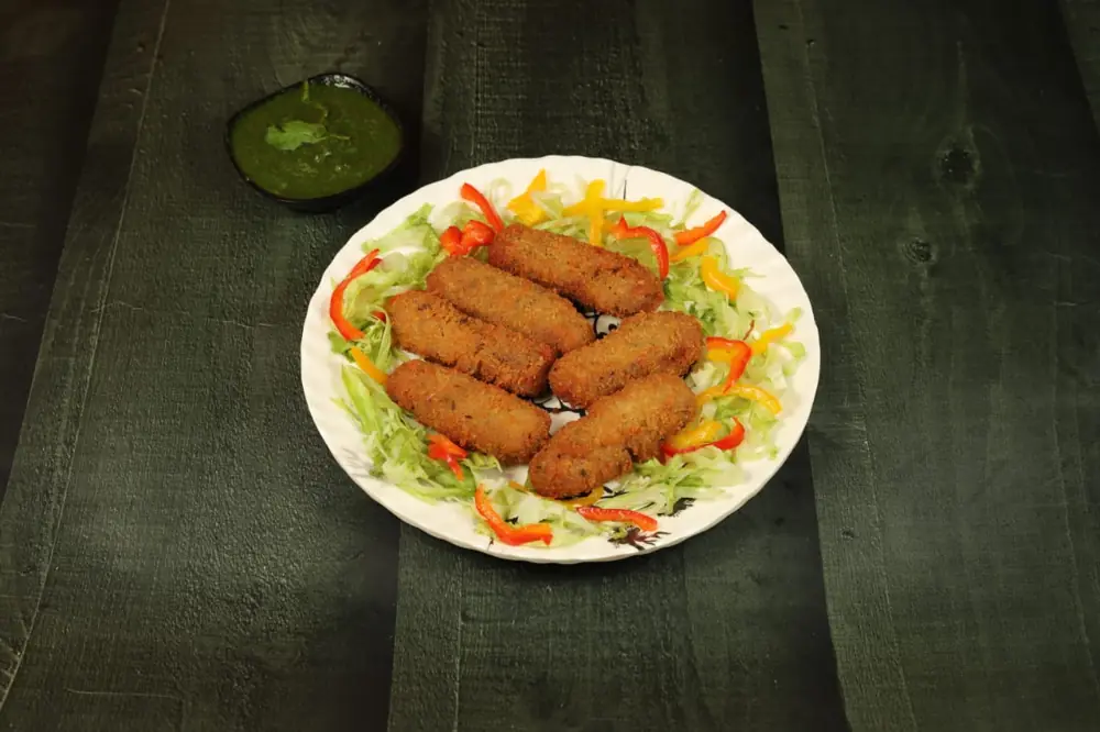 Chicken cheese rolls on shredded cabbage and peppers