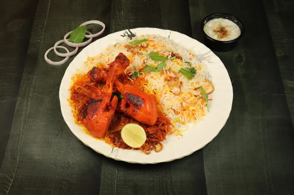 Chicken tandoori biryani with a whole tandoori leg and lemon