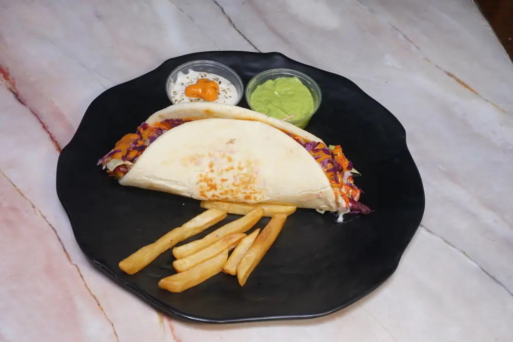 Peri peri chicken shawarma in pita with fries and two dips